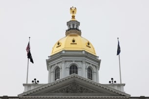 A gold dome flanked by flags