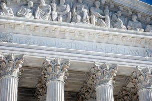 The capitals on top of the pillars on the Supreme Court building's facade.