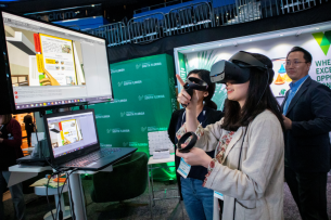 Professor Sanghoon Park and two students engage with virtual reality at a University of South Florida event.